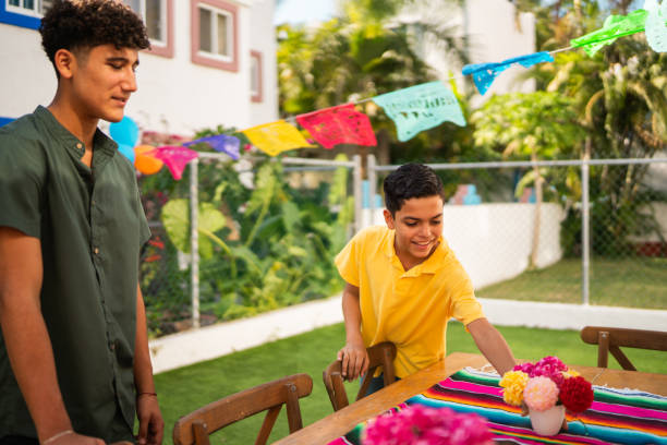 brothers talking and preparing house to party - garden decoration stock pictures, royalty-free photos & images