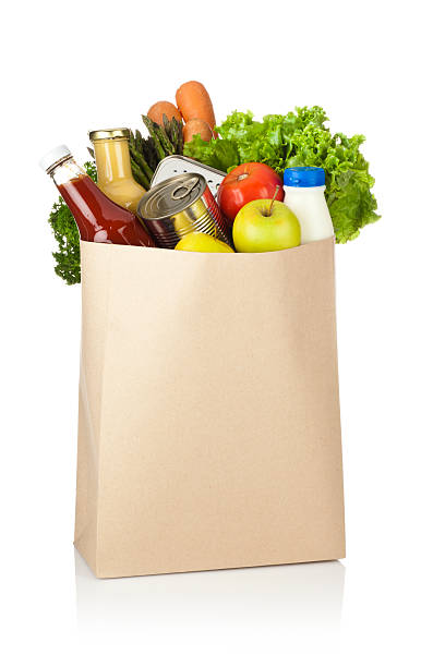 brown paper shopping bag full of groceries on white backdrop - food stock pictures, royalty-free photos & images