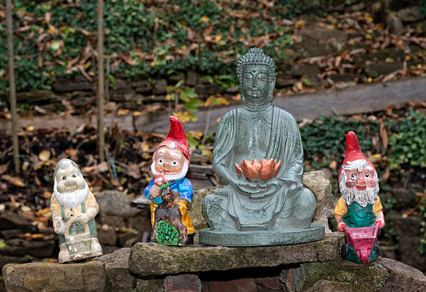 buddha figure and garden gnomes - garden decoration stock pictures, royalty-free photos & images