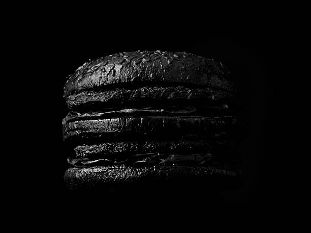 burger on black backdrop - junk food stock pictures, royalty-free photos & images