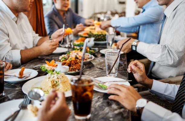 business professionals at a restaurant having dinner - food stock pictures, royalty-free photos & images