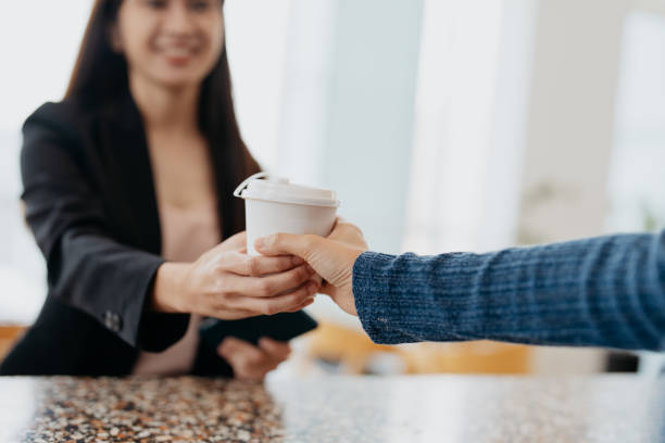 businesswoman buying take out coffee at a cafe - junk food stock pictures, royalty-free photos & images
