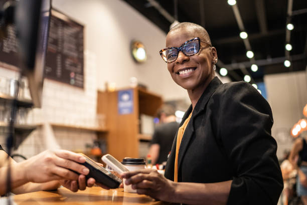 businesswoman paying with qr with mobile in a coffeeshop - junk food stock pictures, royalty-free photos & images