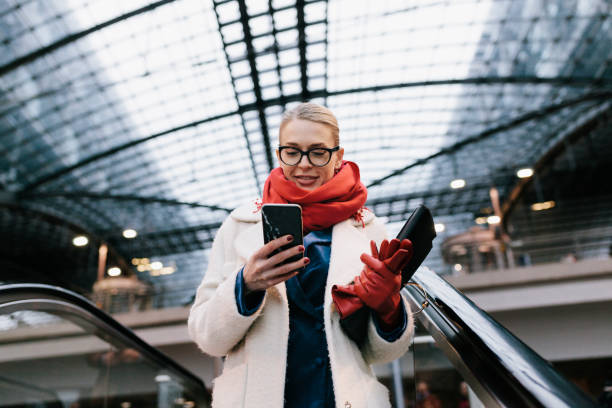 businesswoman texting on way to the office - travel stock pictures, royalty-free photos & images