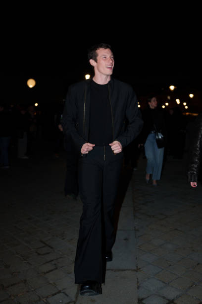 Callum Turner wears a bomber jacket , a black t-shirt, before the Louis Vuitton Menswear Fall-Winter 2025/2026 show as part of Paris Fashion Week on...