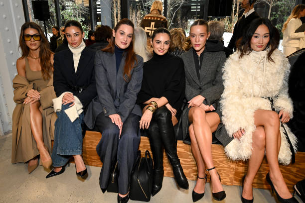 Camila Coelho, Kelsey Merritt, Hannah Berner, Paige DeSorbo, Olivia Ponton, Isabel Tan at the Michael Kors Fall RTW 2025 fashion show as part of New...