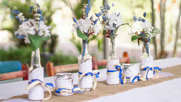 candlestick and flower arrangement on table - garden decoration stock pictures, royalty-free photos & images