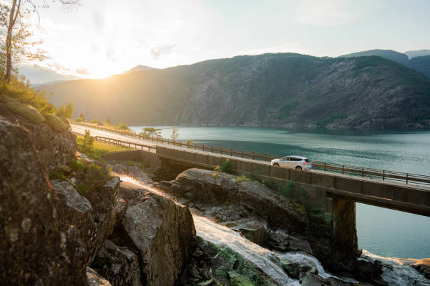 car on bridge across the river in norway - travel stock pictures, royalty-free photos & images
