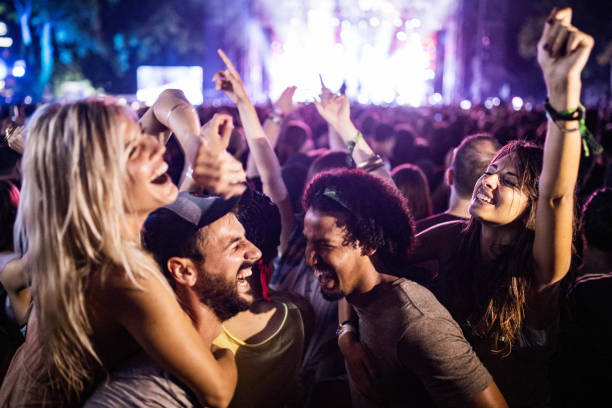 carefree couples having fun while dancing on music festival. - concert stock pictures, royalty-free photos & images