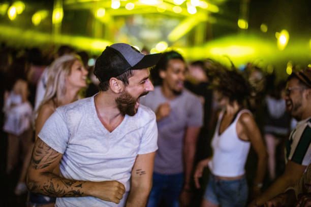 carefree man screaming while having fun on music concert. - concert stock pictures, royalty-free photos & images