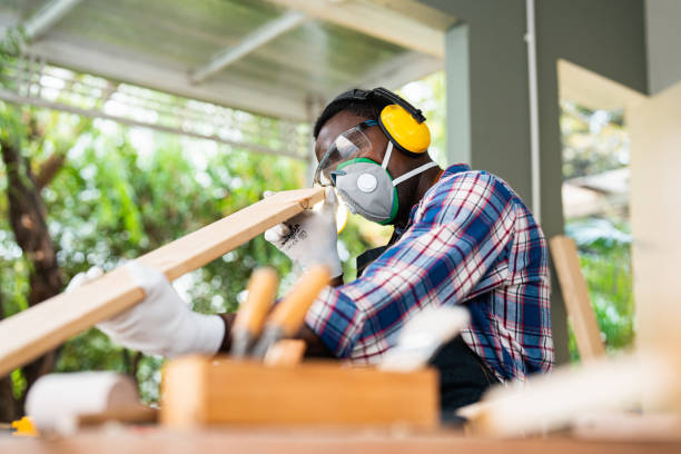 carpenter handling a piece of wood above his workbench in his workshop. - home decoration stock pictures, royalty-free photos & images