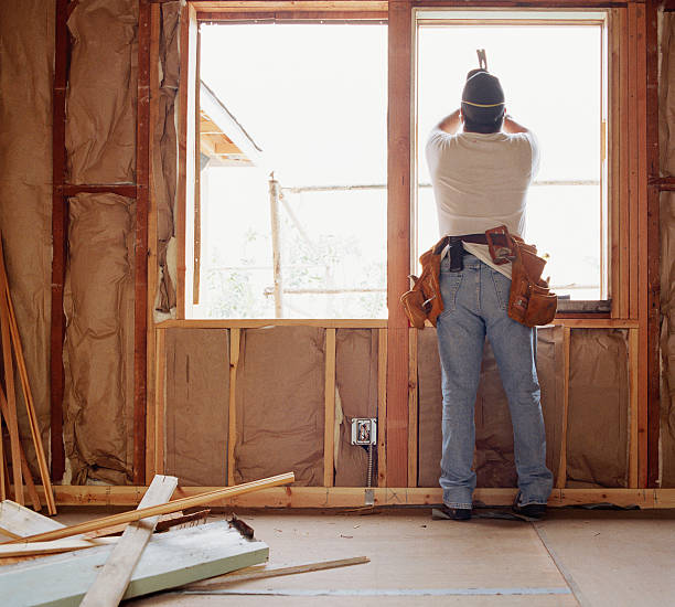 carpenter working on window at house renovation site, rear view - home decoration stock pictures, royalty-free photos & images