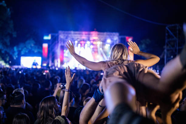 carrying a woman on music festival! - concert stock pictures, royalty-free photos & images