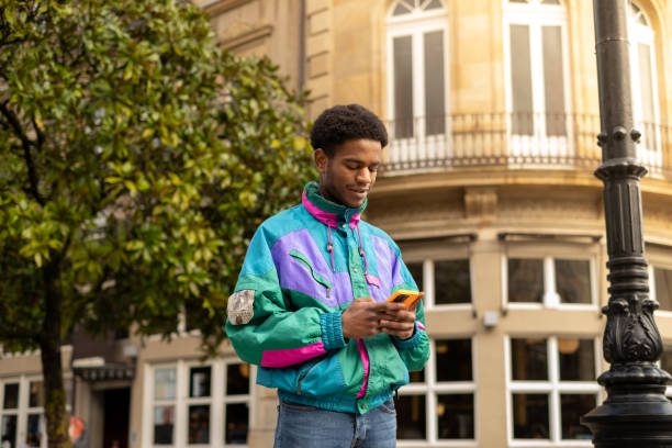 casual vintage african man using phone in the city - fashion stock pictures, royalty-free photos & images