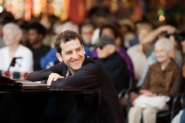 caucasian musician sitting at piano - concert stock pictures, royalty-free photos & images