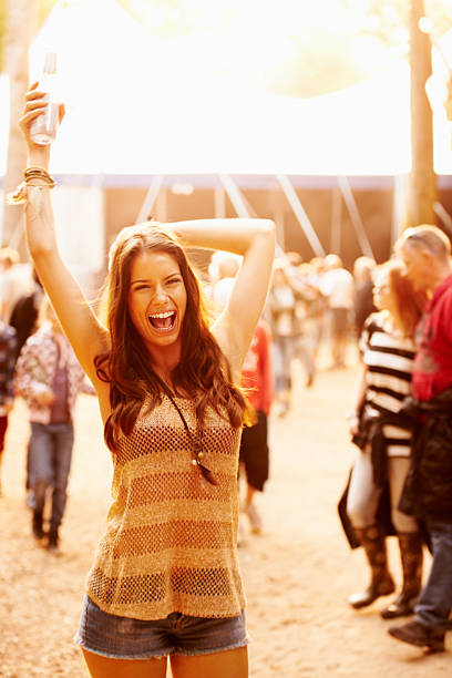 caught up in the festivities - concert stock pictures, royalty-free photos & images