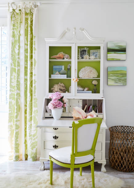 chair and arranged cabinet in living room at luxury cottage - home decoration stock pictures, royalty-free photos & images