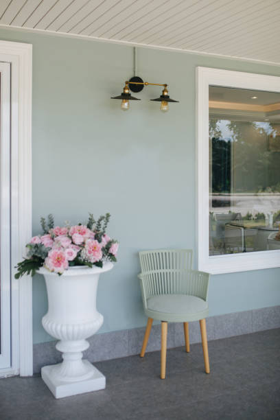 chairs and flower pots on a blue background. - garden decoration stock-fotos und bilder