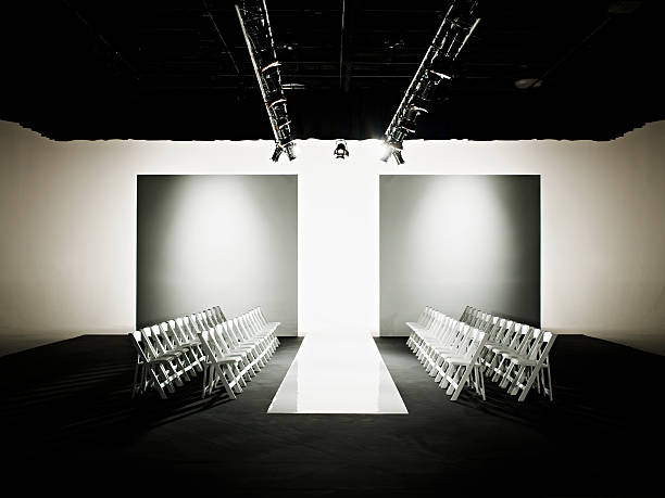 chairs around catwalk set for fashion show - fashion week stock pictures, royalty-free photos & images