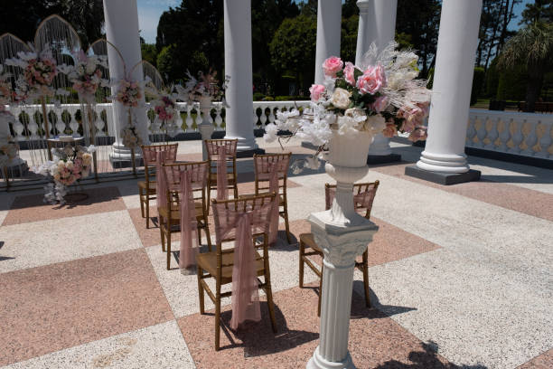 chairs for a wedding reception decorated with fabric or a veil. wedding ceremony in the open air, bouquets of flowers. beautiful decoration and decoration, wedding decor. - garden decoration stock pictures, royalty-free photo