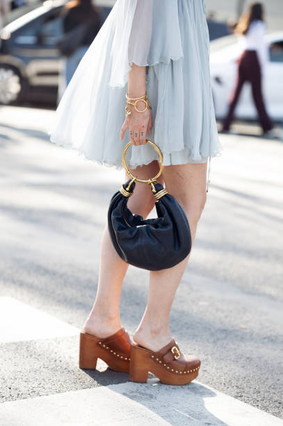 Charlotte Groeneveld wears light blue mini dress, blue Chloé bag, brown mules outside the Chloe fashion show during the Womenswear Fall/Winter...
