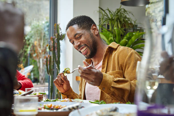 cheerful black man having lunch with family - food stock pictures, royalty-free photos & images