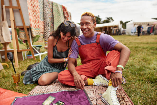 cheerful couple sitting with tarot cards at park - concert stock pictures, royalty-free photos & images