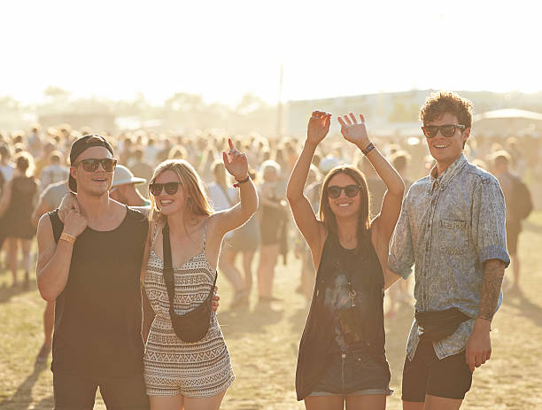 cheerful friends at music festival - concert stock pictures, royalty-free photos & images