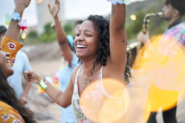 cheerful photo of an african american young woman dancing in a beach party in the summer season. - concert stock pictures, royalty-free photos & images