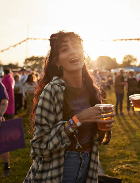 cheerful woman with beer glass at music festival - concert stock pictures, royalty-free photos & images