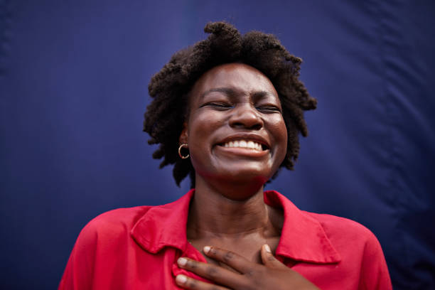 cheerful young woman smiling with eyes closed - hairstyle stockfoto's en -beelden