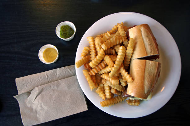 cheese steak sandwich with crinkle cut potato chips on a white plate at a diner in new york city, united states of america - junk food stock pictures, royalty-free photos & images