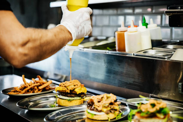 chef preparing artisan burgers - junk food stock pictures, royalty-free photos & images