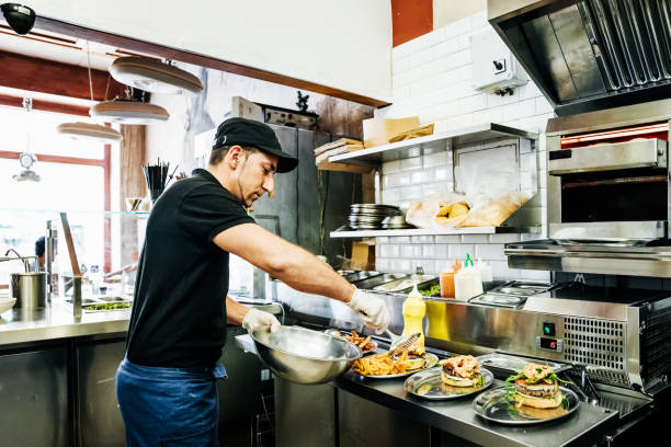 chef preparing food for customers - junk food stock pictures, royalty-free photos & images