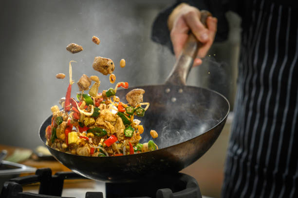 chef preparing food in restaurant kitchen - food stock pictures, royalty-free photos & images