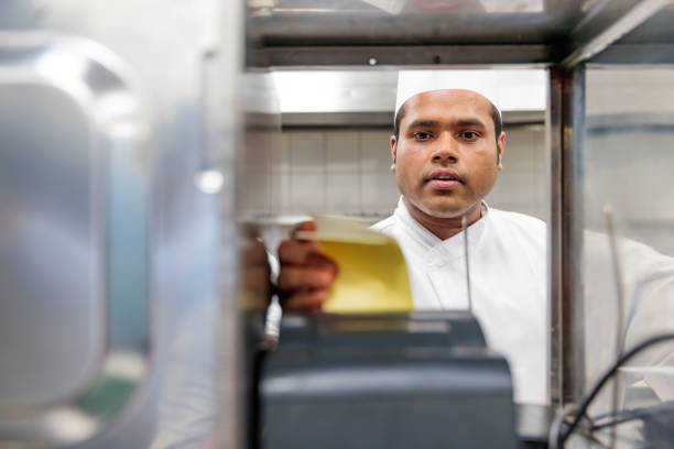 chef reviewing the order received from the restaurant - junk food stock pictures, royalty-free photos & images