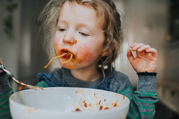 child eating spaghetti - food stock pictures, royalty-free photos & images