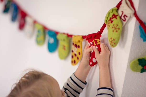 child opening advent calendar - home decoration stock pictures, royalty-free photos & images