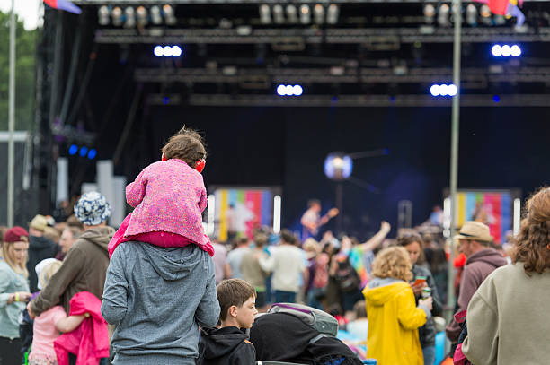 child wearing ear defenders at a scottish music festival - concert stock pictures, royalty-free photos & images