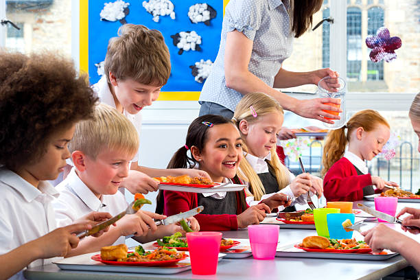 children eating school dinners - food stock pictures, royalty-free photos & images