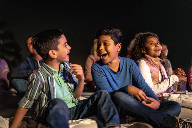 children talking and laughing at the outdoors cinema - concert stock pictures, royalty-free photos & images