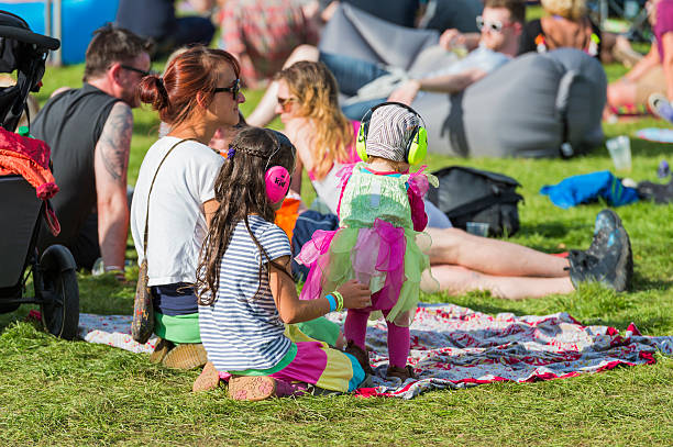 children wearing ear defenders at a music festival in scotland - concert stock pictures, royalty-free photos & images