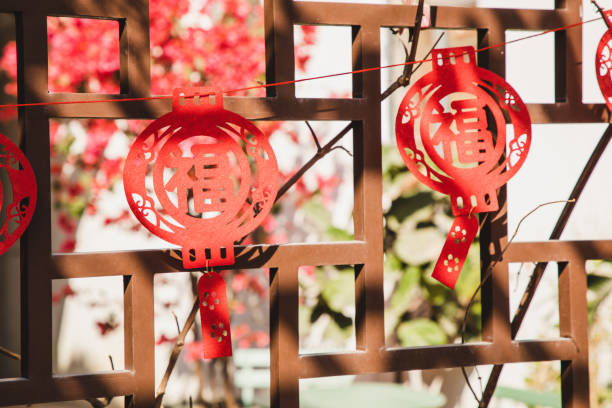 chinese new year paper craft decorations hanging outside on the front or back yard - garden decoration stock-fotos und bilder