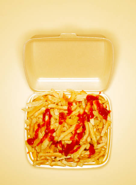 chips covered with ketchup in take out box, overhead view - junk food stock pictures, royalty-free photos & images