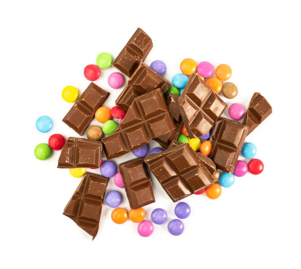 chocolate and coloured candy - junk food stock pictures, royalty-free photos & images