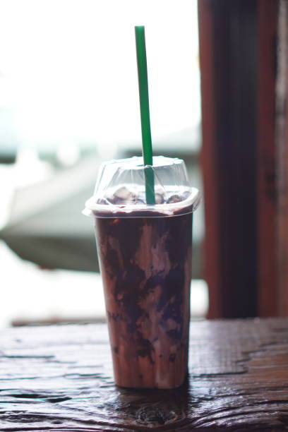 chocolate milk ice in plastic cup - junk food stock pictures, royalty-free photos & images