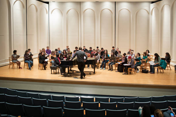 choir and conductor on stage - concert stock pictures, royalty-free photos & images