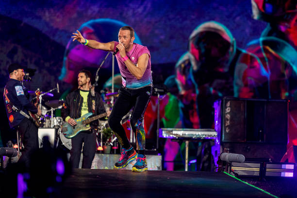 Chris Martin, Guy Berryman and Jonny Buckland of Coldplay perform live on stage at Parken Stadium on July 5, 2023 in Copenhagen, Denmark.
