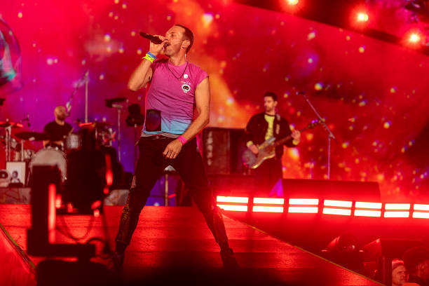 Chris Martin, Guy Berryman and Will Champion of Coldplay perform live on stage at Parken Stadium on July 5, 2023 in Copenhagen, Denmark.