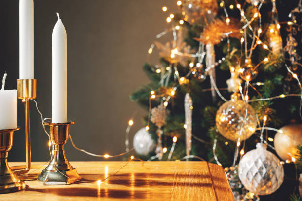 christmas decorations with white candles on table - home decoration stock-fotos und bilder